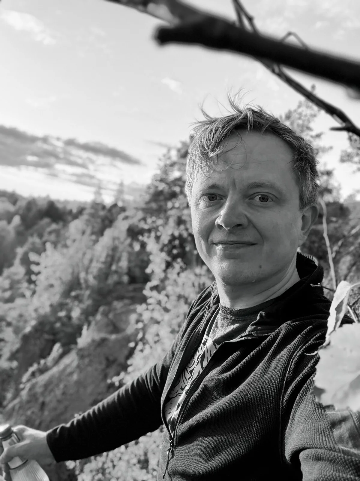Juha outdoors on a rocky hillside in the evening sun